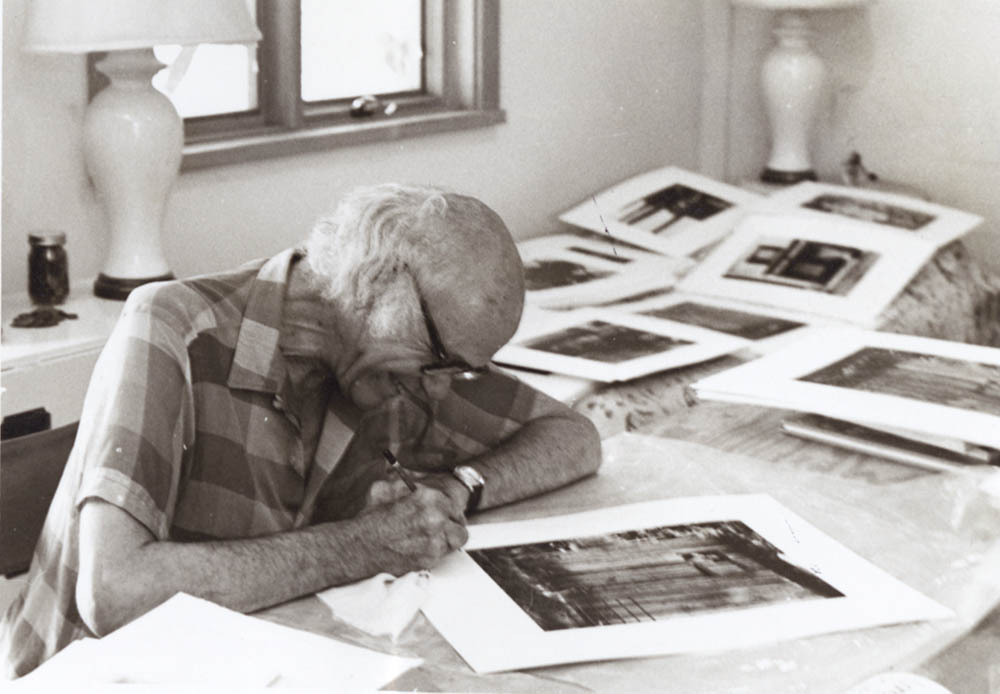 Amy Conger - Portrait of Beaumont Newhall with Photographs