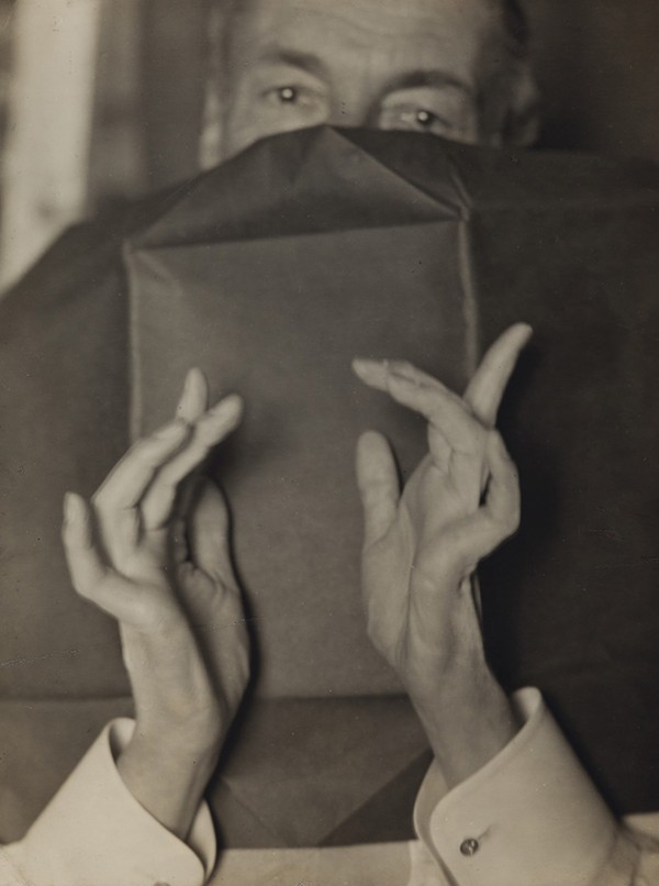 Several vintage Man Ray photographs, including "Portrait of a Half-Hidden Man With Expressive Hands" are in the auction.